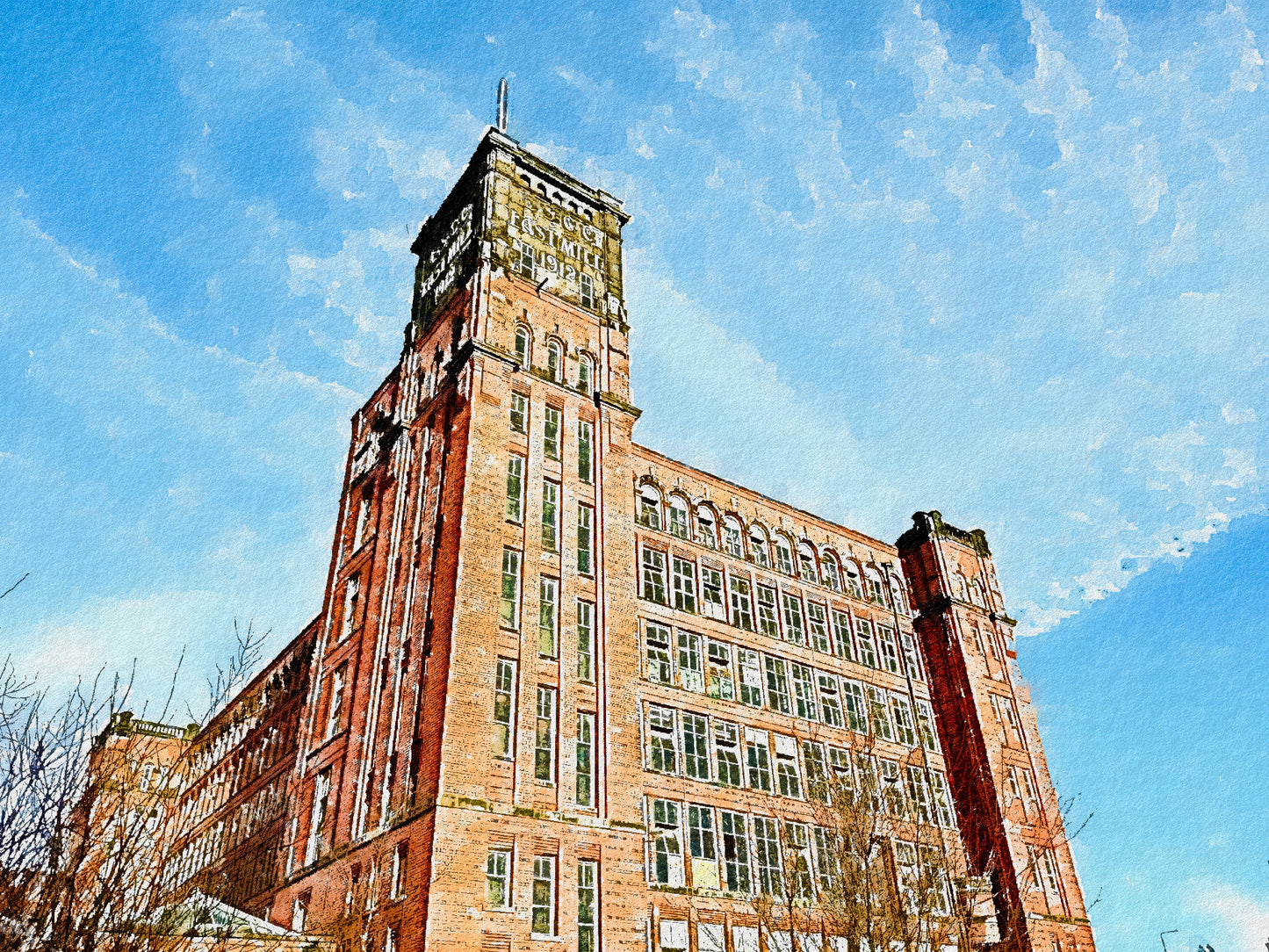 Tall brick mill building with a clock tower against a blue sky